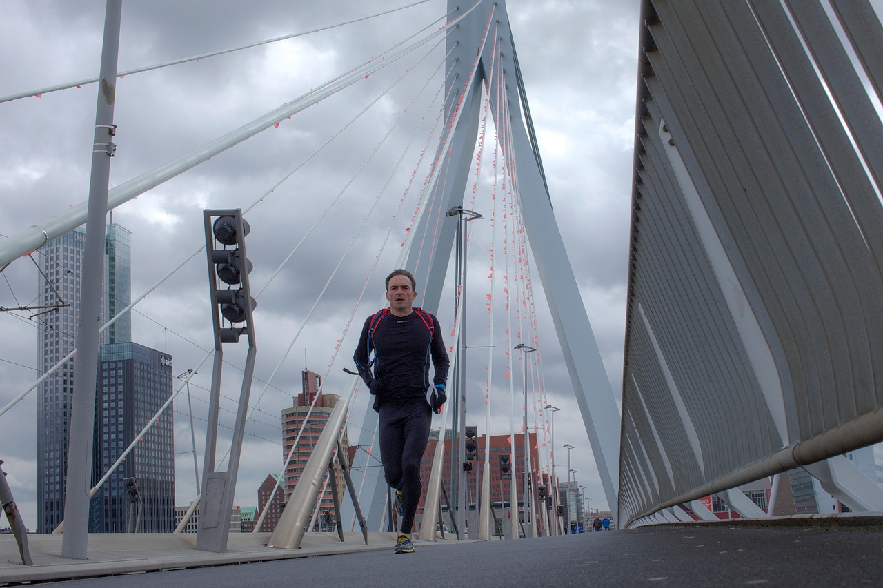 running erasmus bridge man free photo