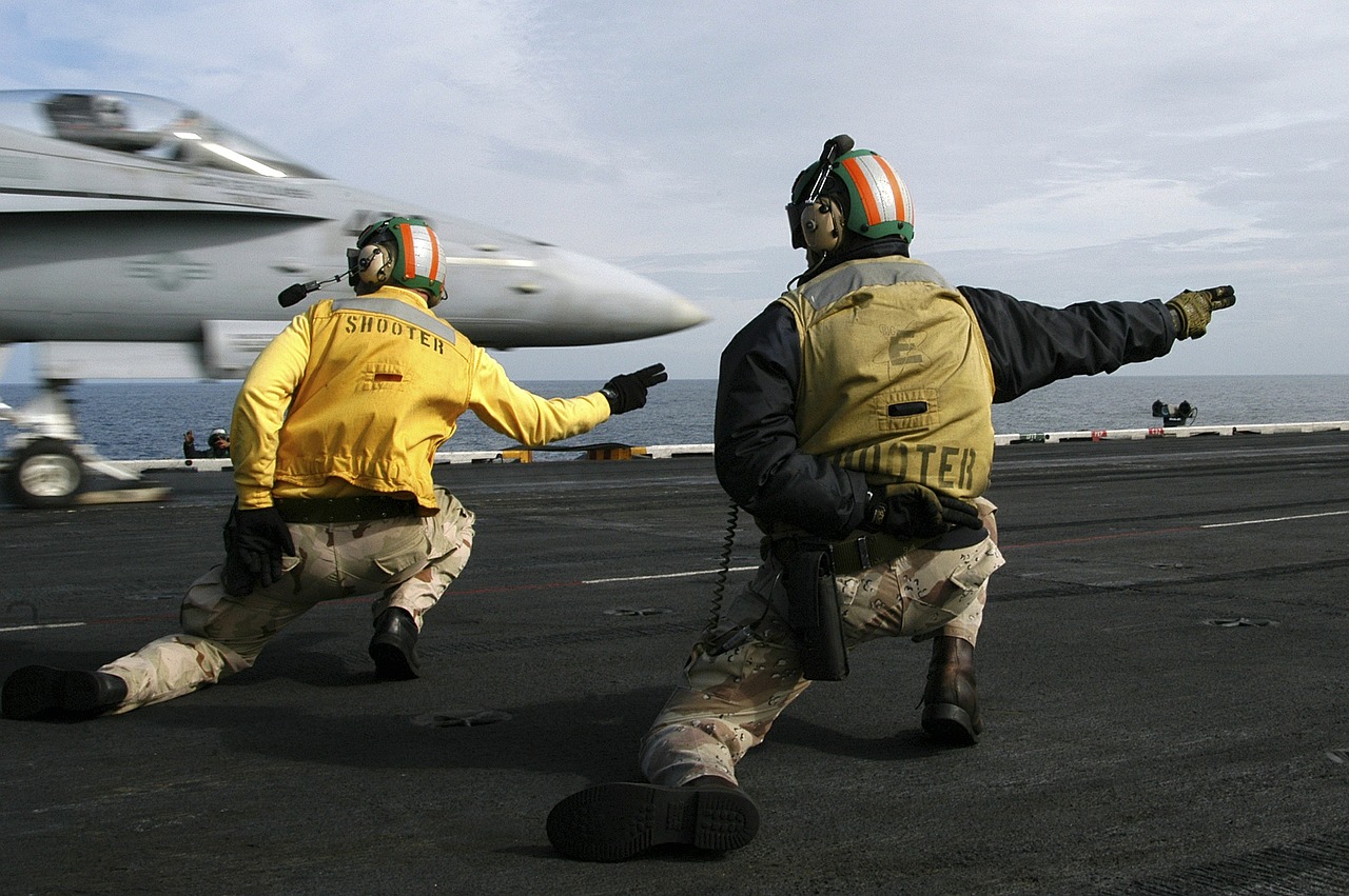 sailors signal to launch jet aircraft carrier free photo