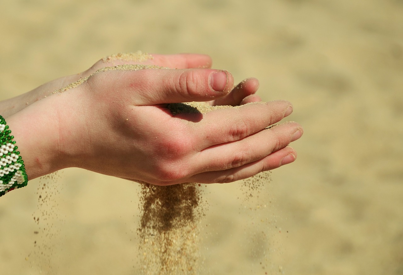 sand hands melt away free photo