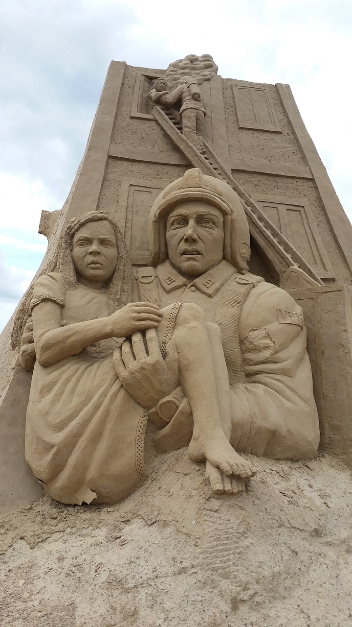 sand sculpture fire fighter marvel free photo