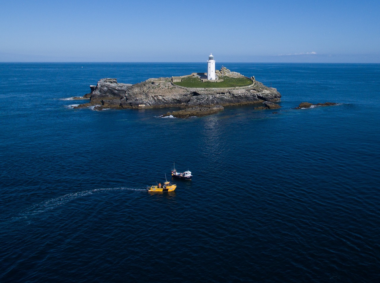sea lighthouse fishing boats free photo