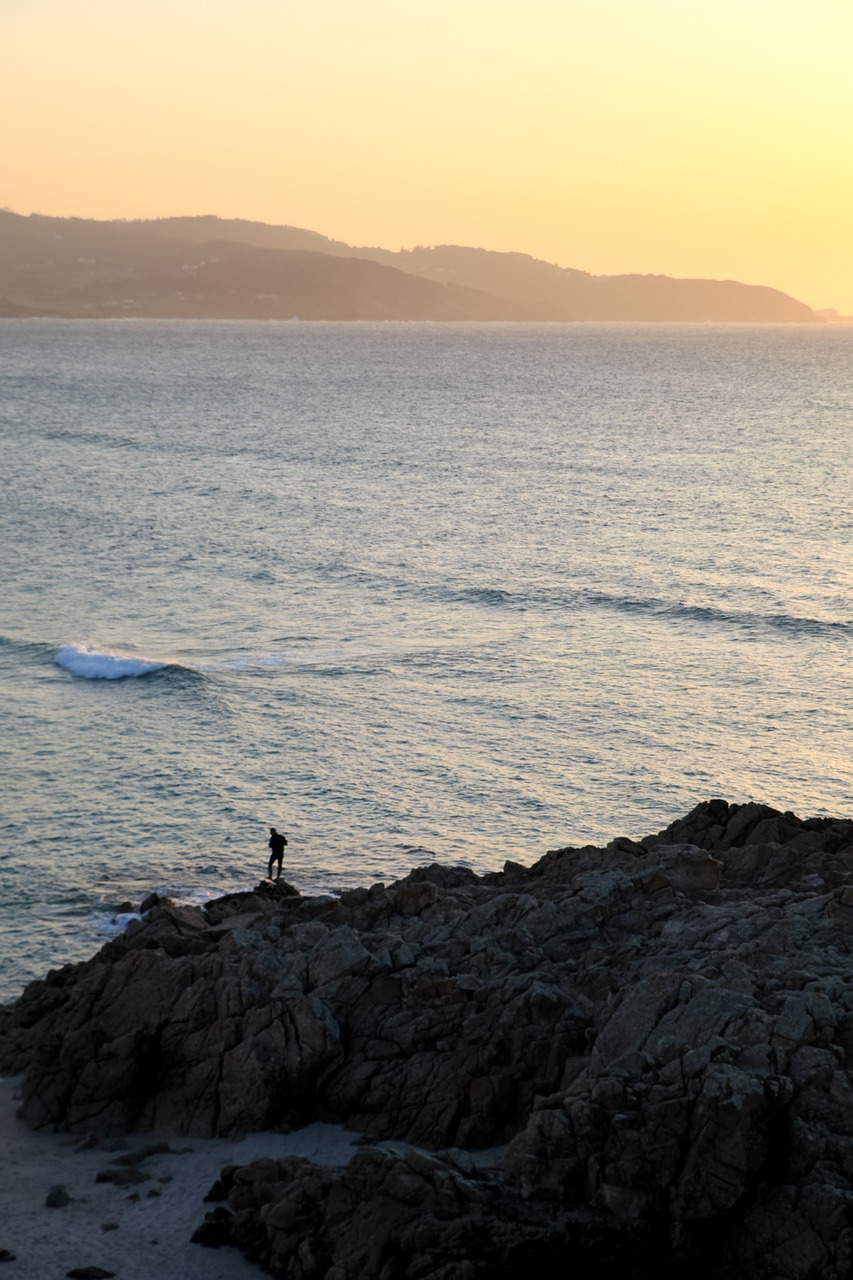 sea fisherman rocks free photo