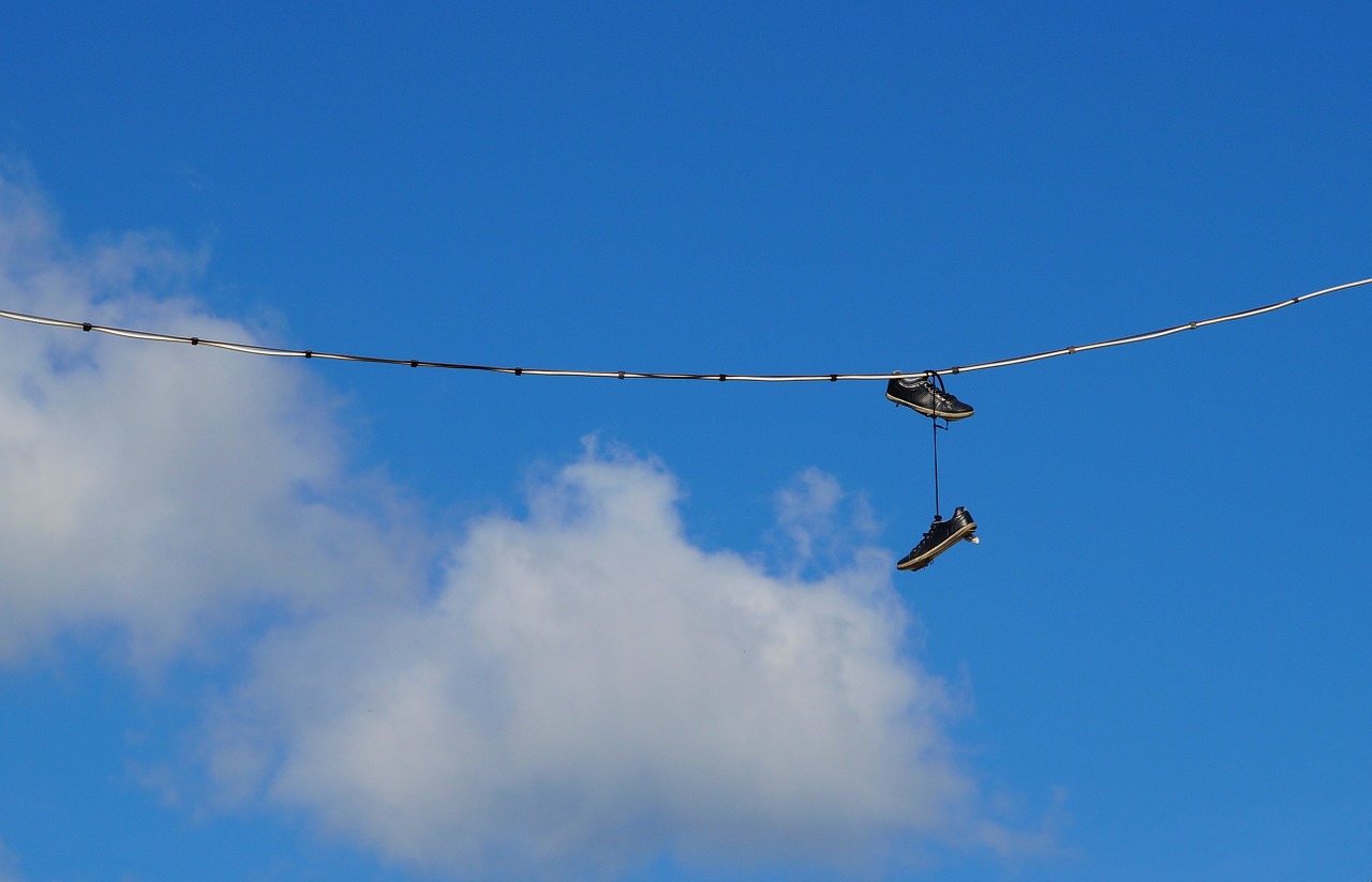 shoe tossing sky shoes free photo
