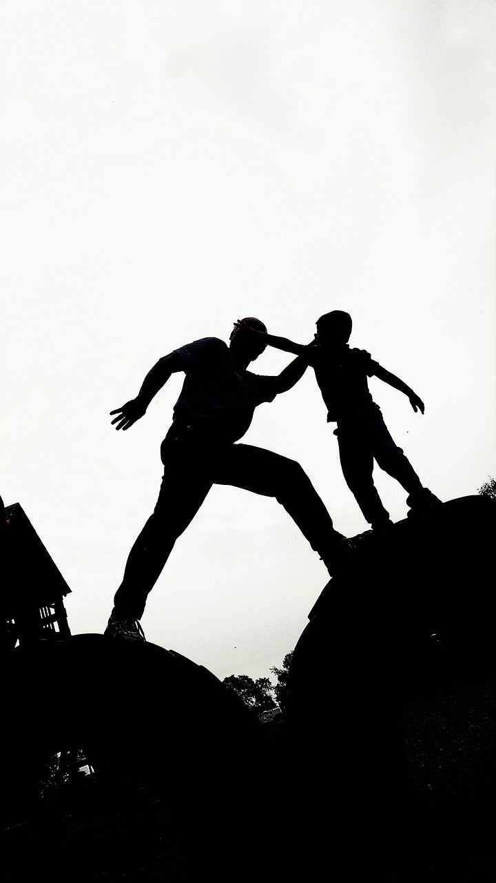 silhouette father climbing free photo