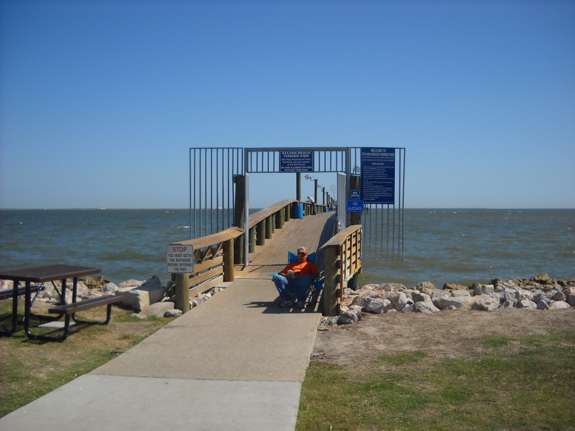 pier fishing pier man sitting lawn chair free photo