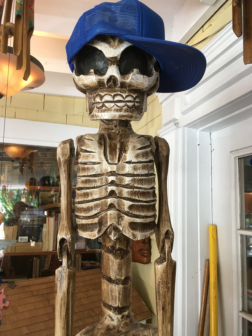 skeleton with baseball hat artificial sculpture with blue hat skeleton with hat free photo