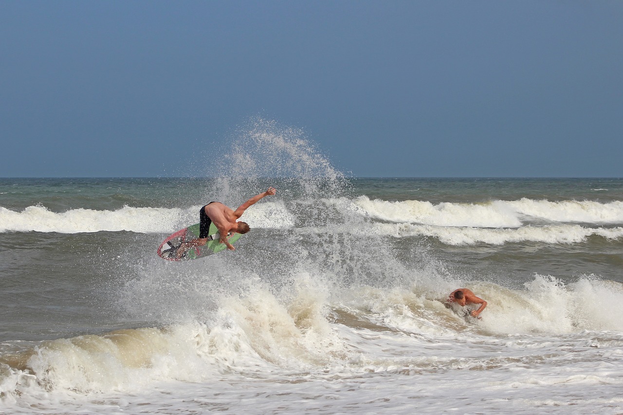 skimboarding  surfing  beach free photo