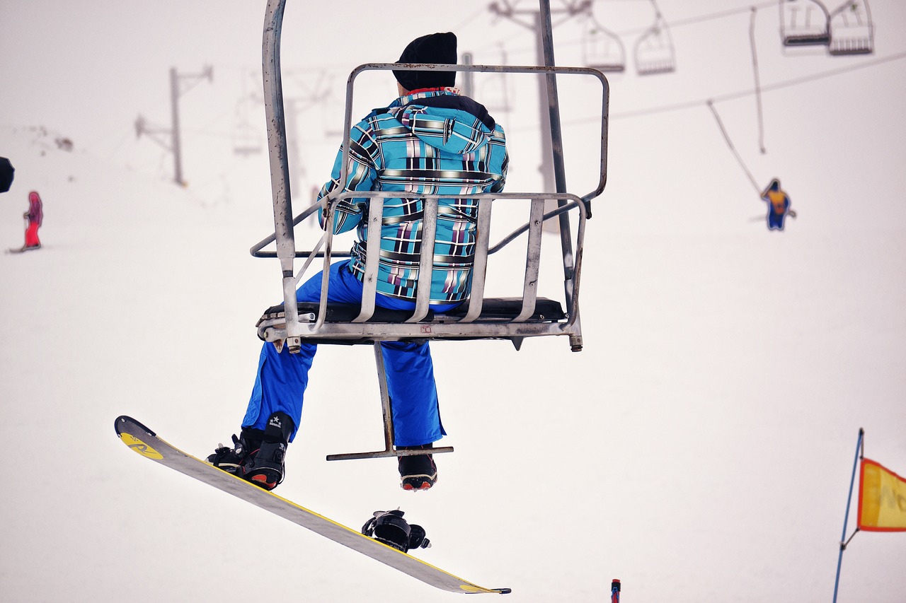 snowboarder chairlift snow free photo