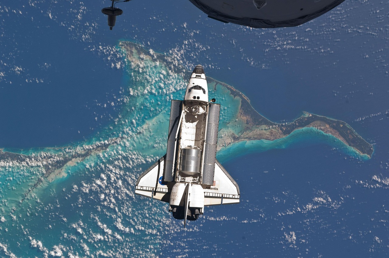 space shuttle atlantis docking space station free photo
