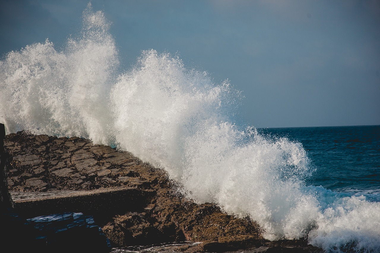 splashing wave breakwater free photo