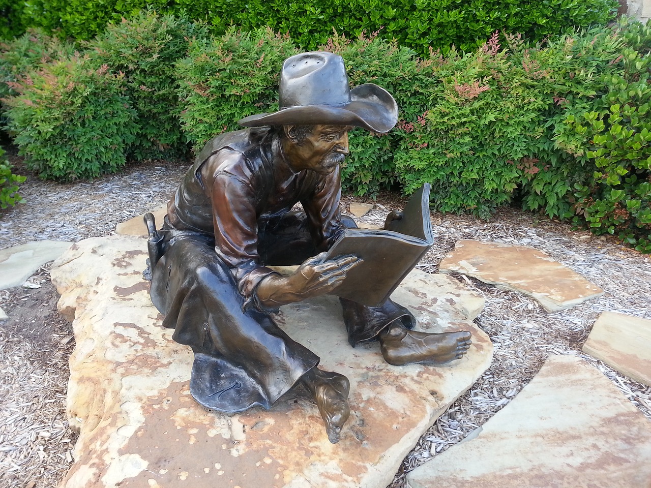 statue cowboy reading free photo