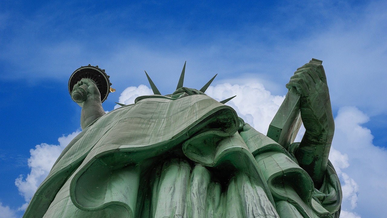 statue of liberty clouds liberty enlightening the world free photo