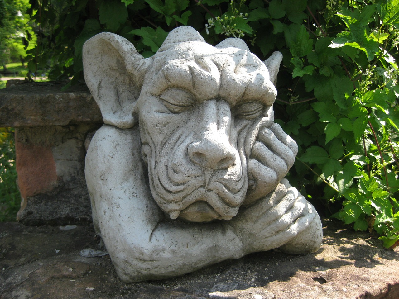 stone figure making a face garden figurines free photo