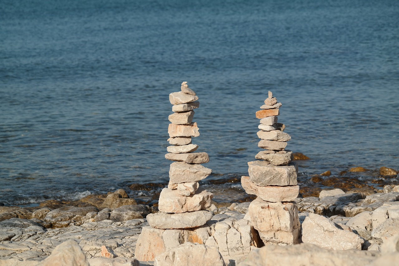 stone towers sea beach free photo