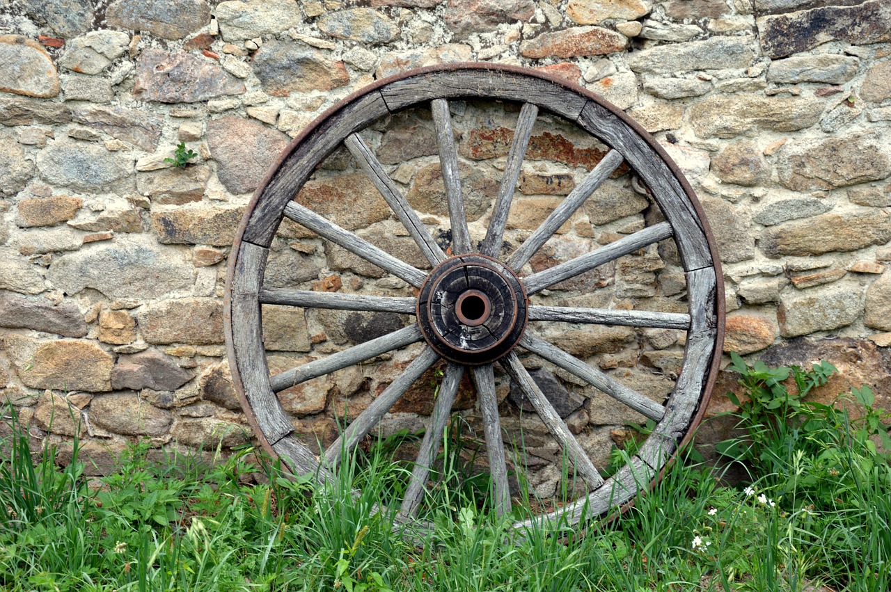 stone wall cartwheel wooden wheel free photo