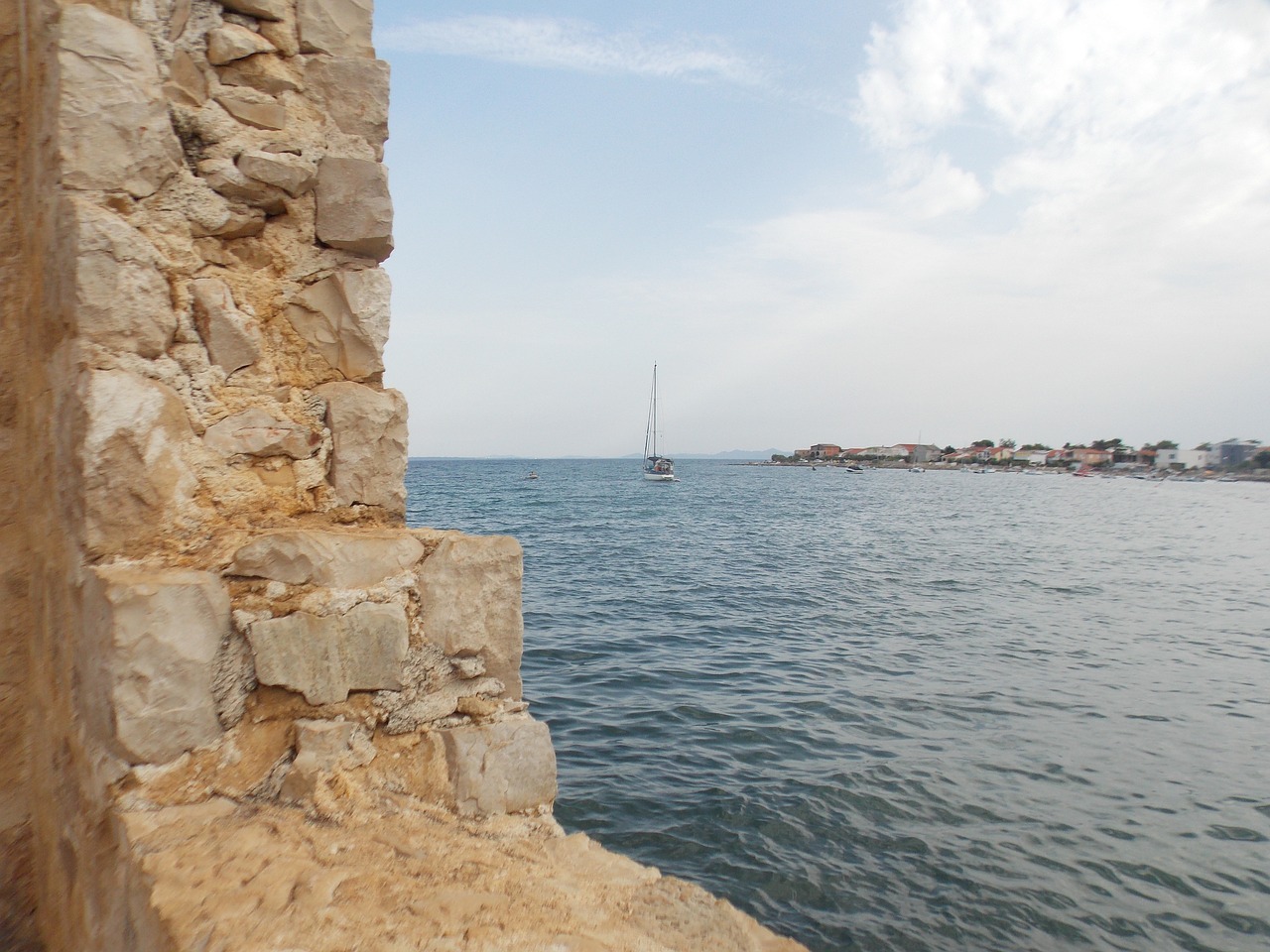 stone wall sea blue sky free photo