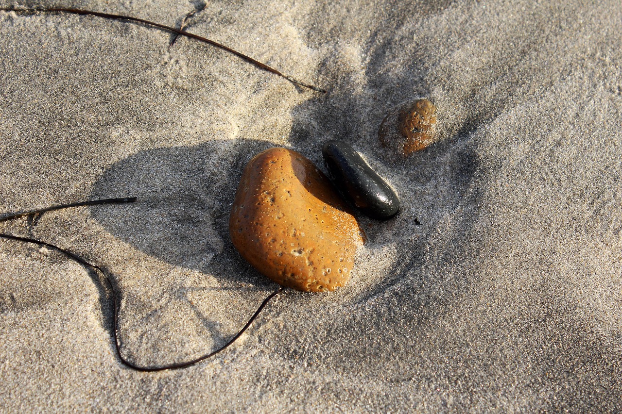 stones beach sandy beach free photo