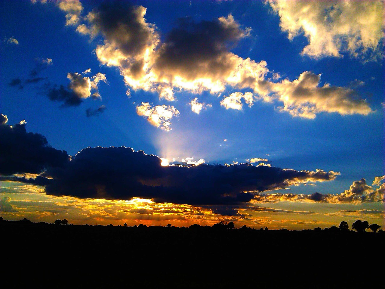sun behind clouds free photo
