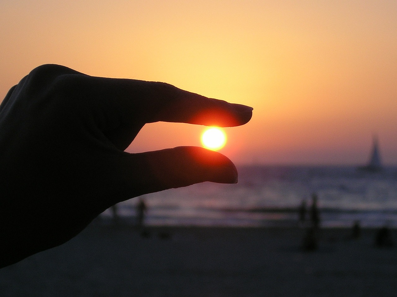 sun in the hand fingers sunset free photo