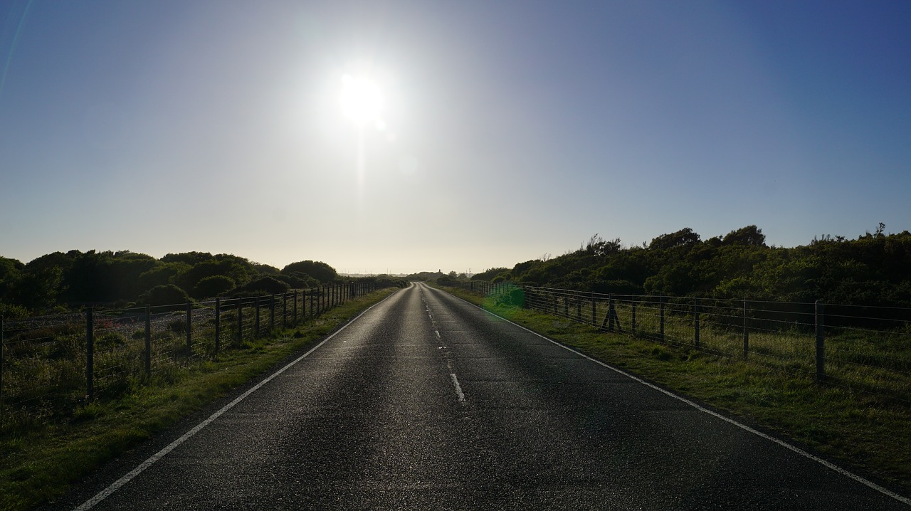 sun on road horizon perspective free photo