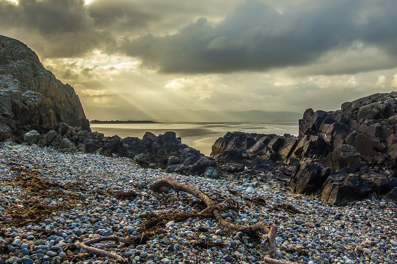 sun rays rocks beach free photo