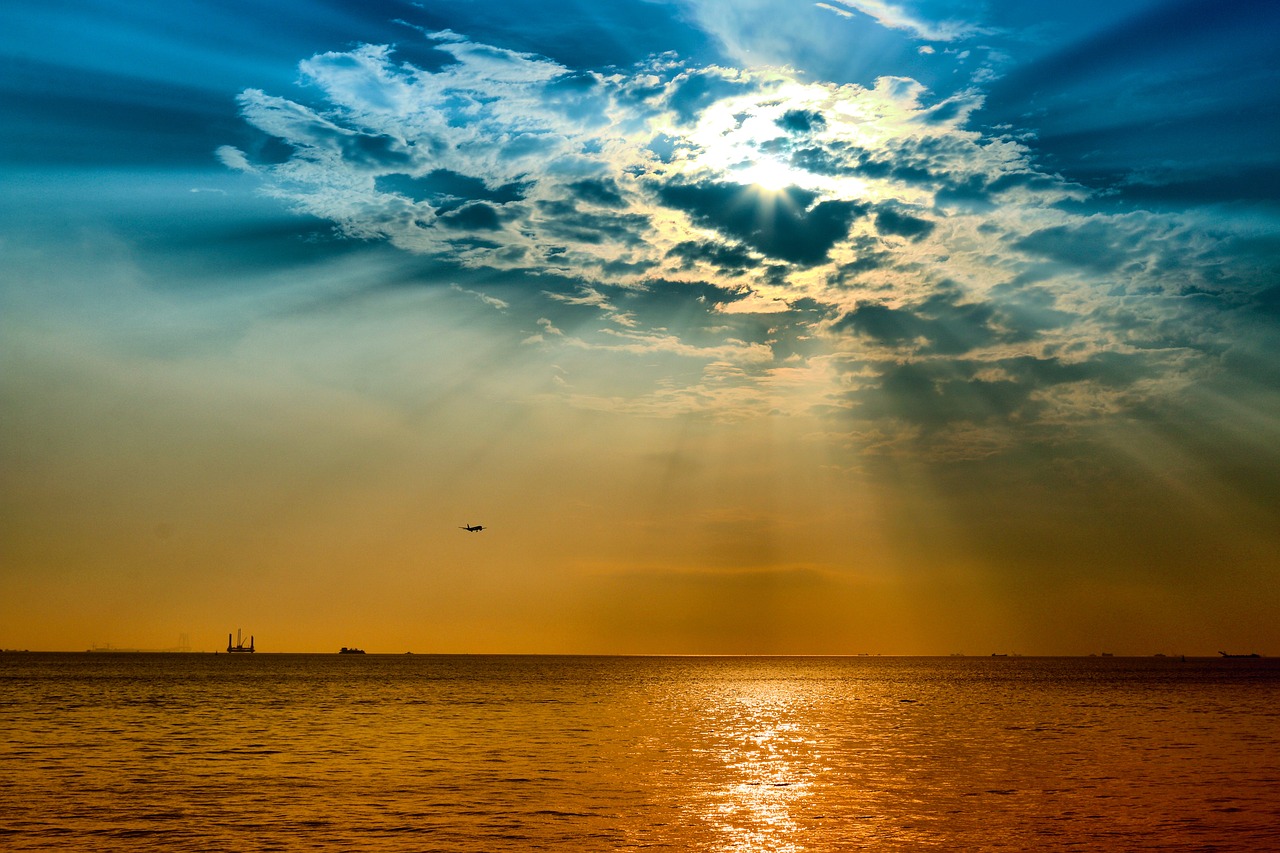 sun rays  airplane  sea free photo