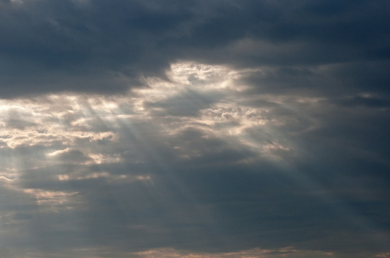 sunbeams protruding through clouds  clouds  sky free photo