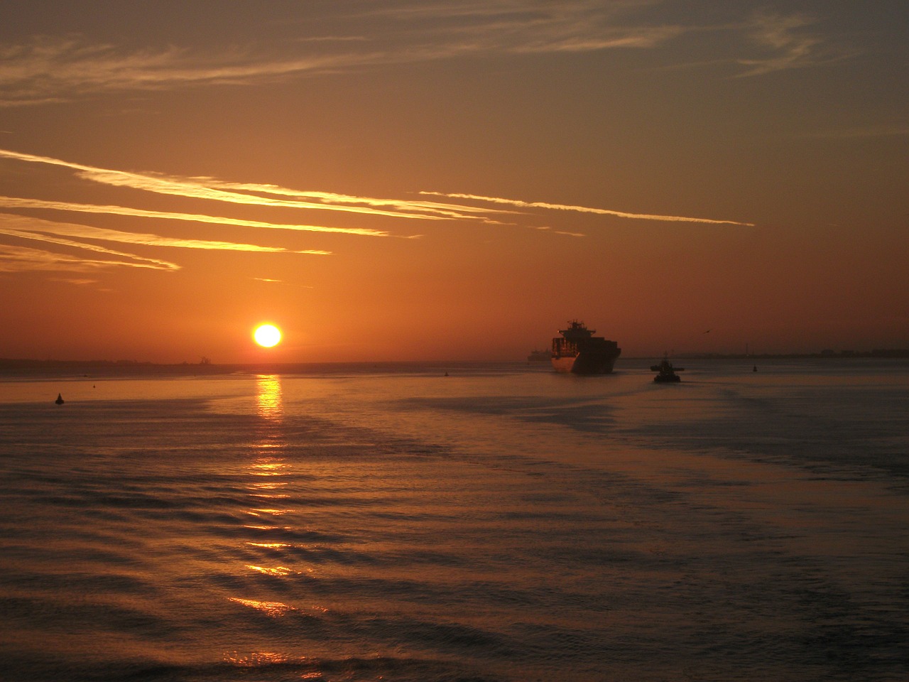 sunrise over water ships seascape free photo