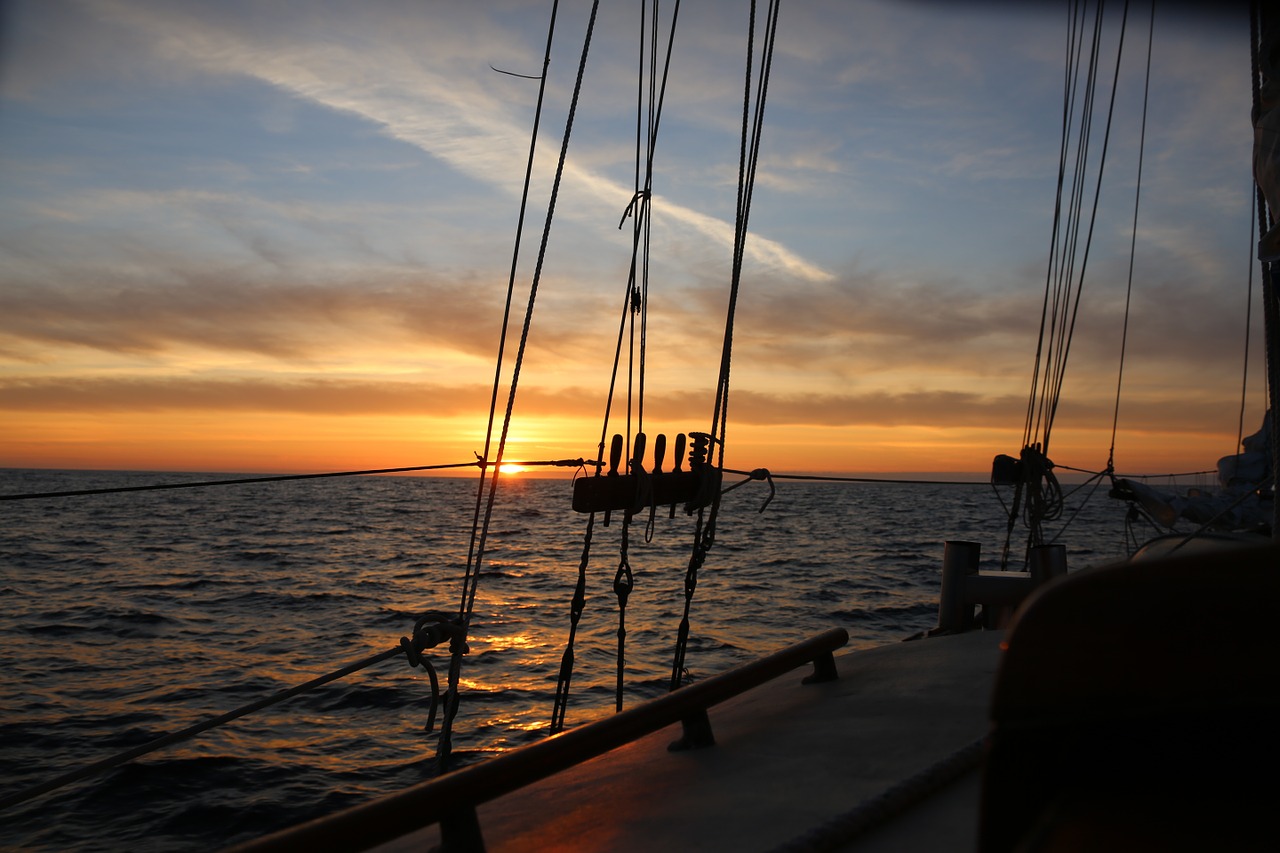 sunset ocean sailboat free photo