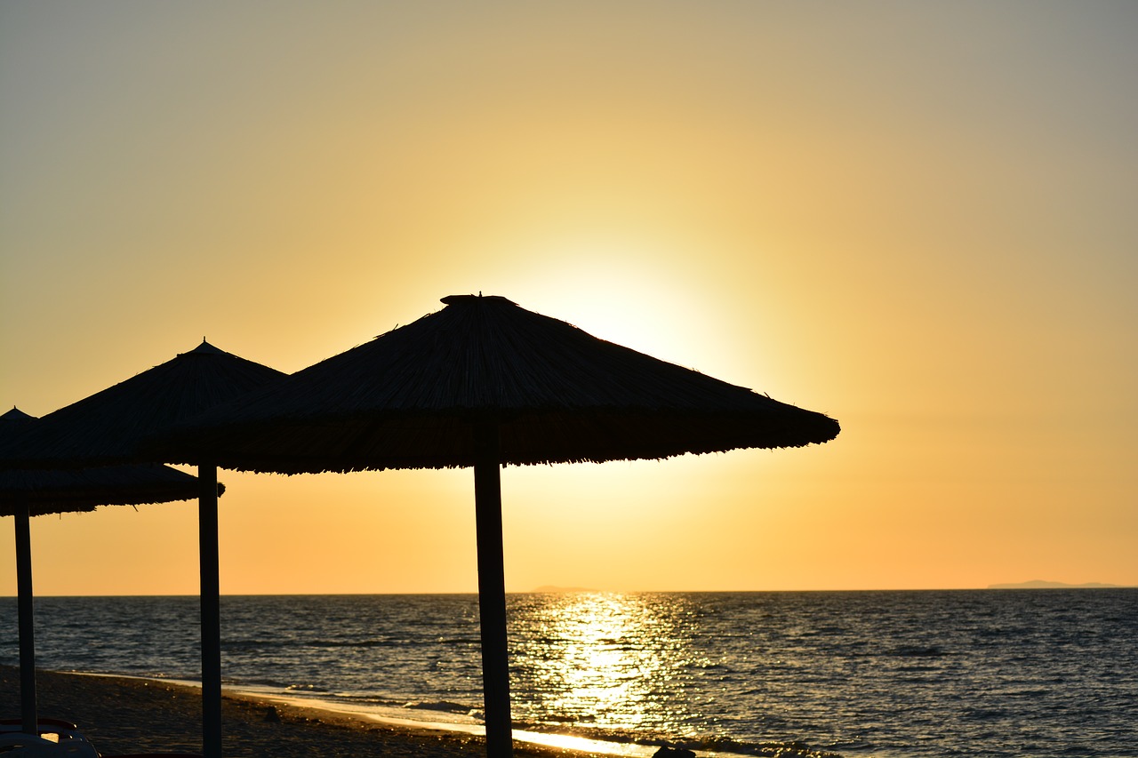 sunset sea parasols free photo