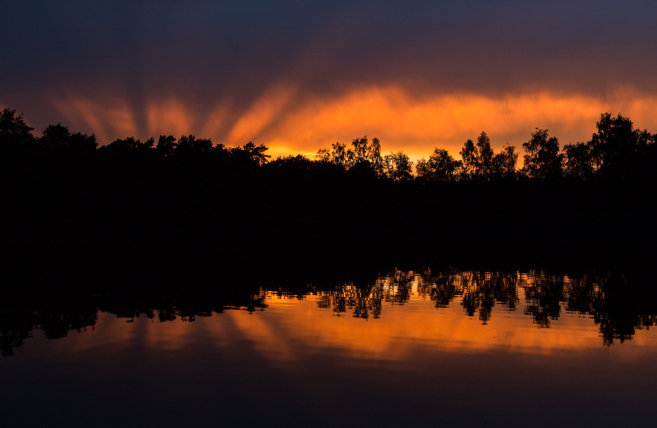 sunset mirroring water free photo