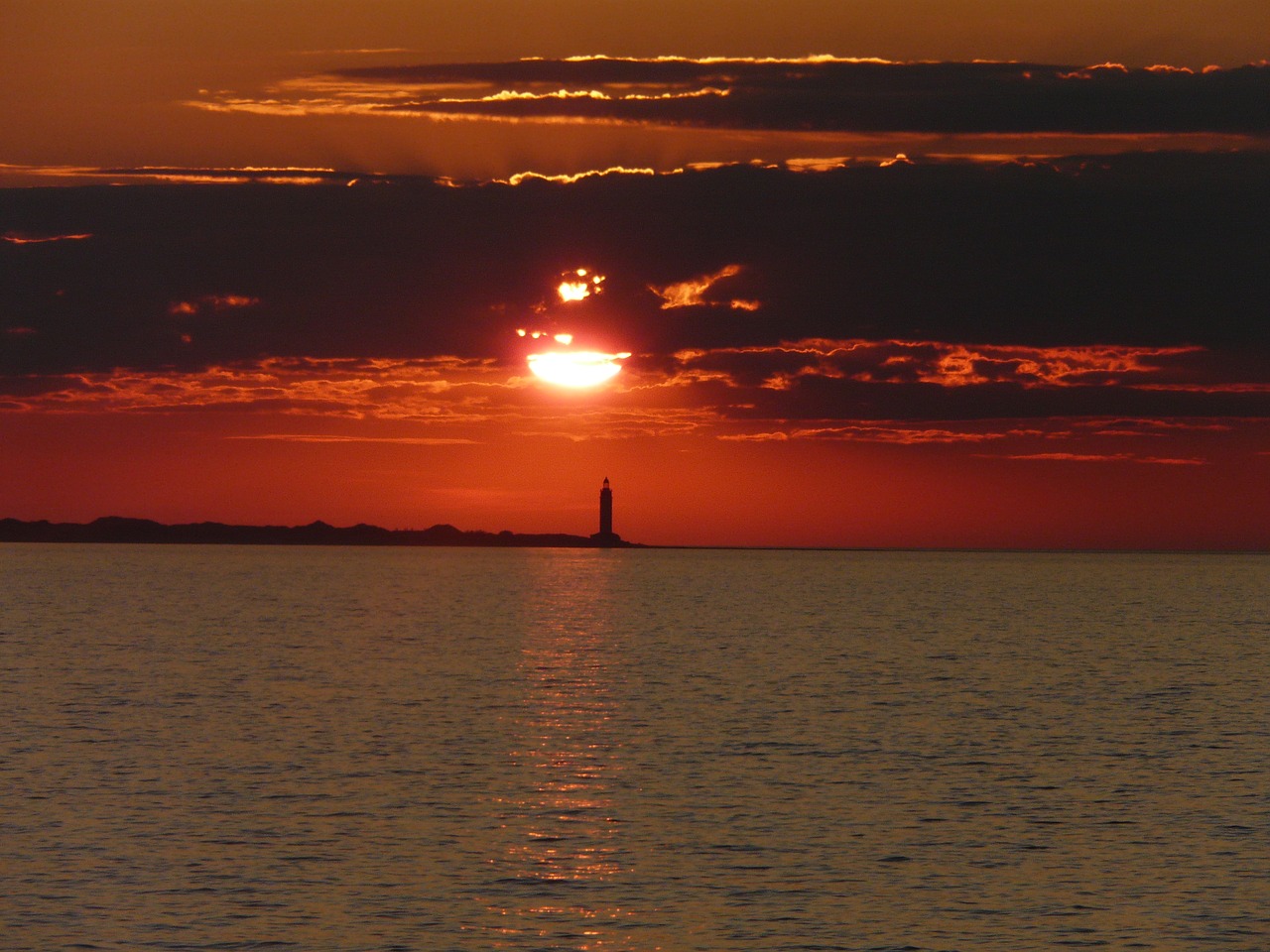 sunset lighthouse sea free photo