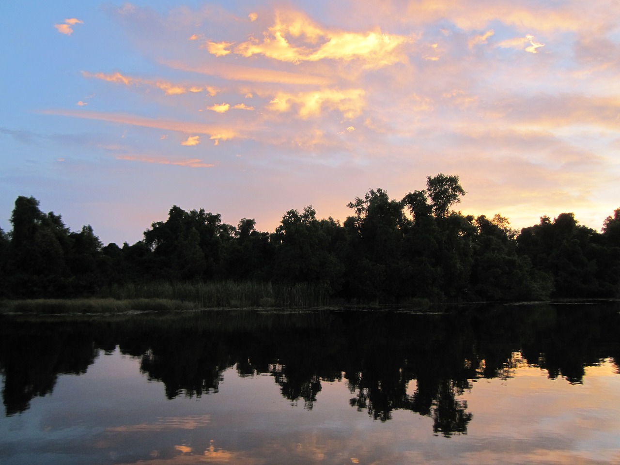 sunset mirroring water free photo