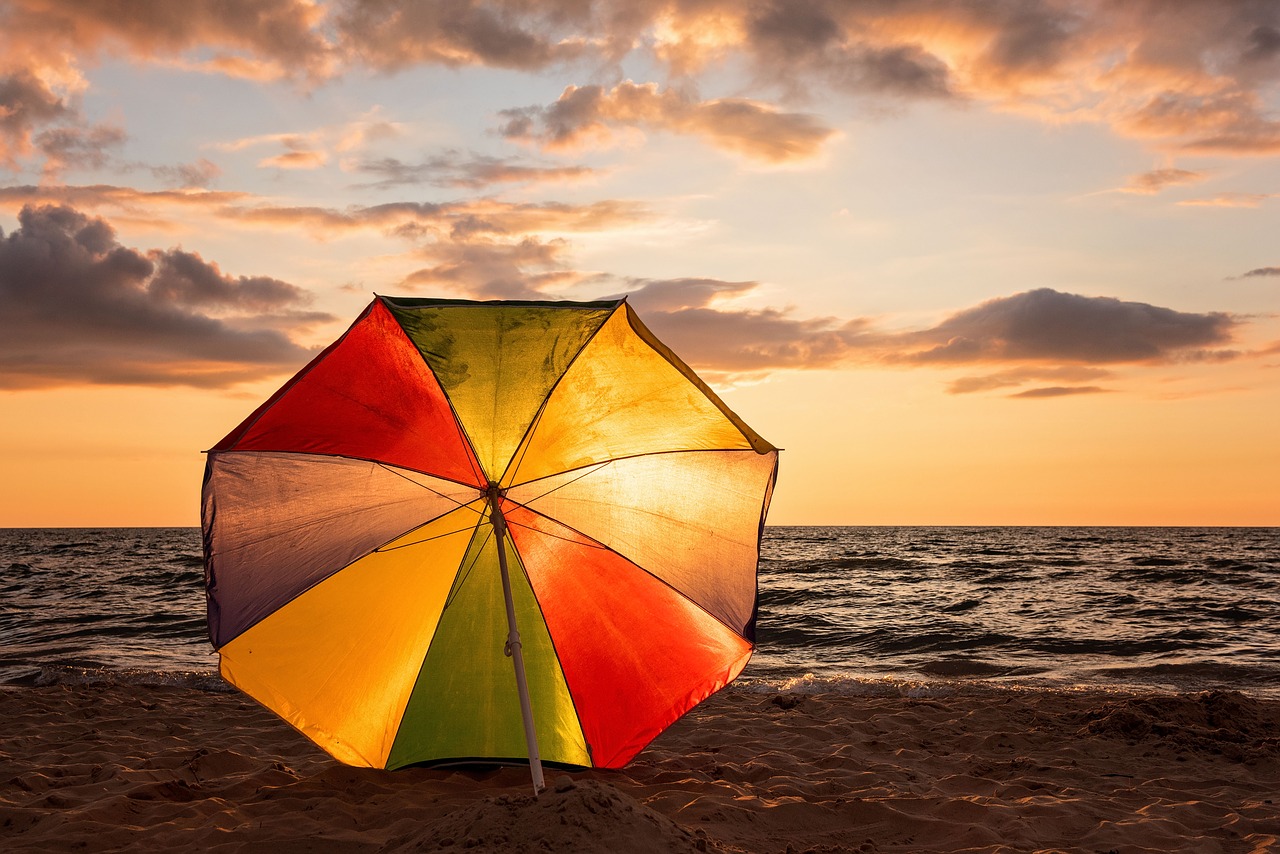 sunset beach umbrella ocean free photo