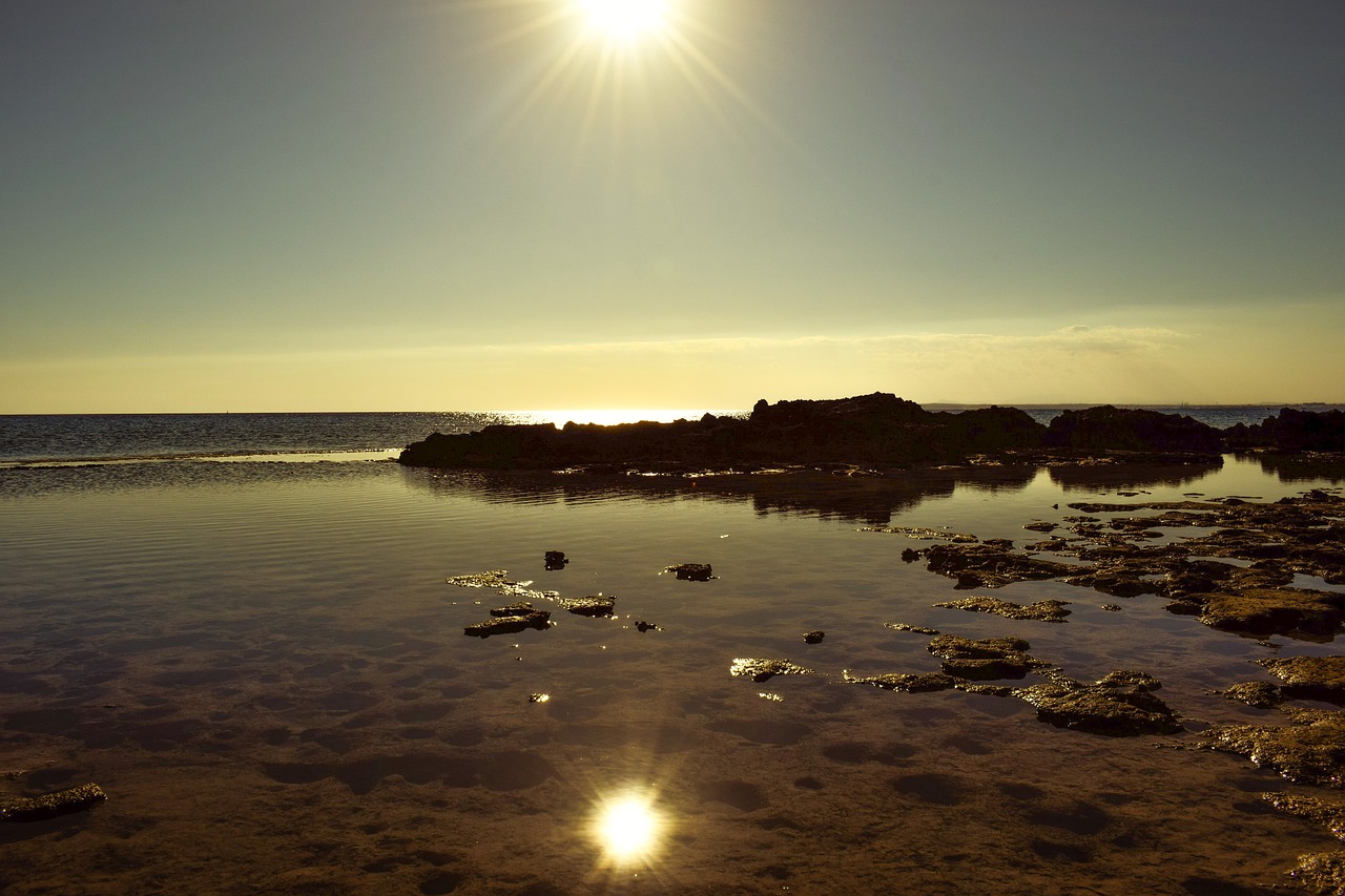 sunset rocky coast reflections free photo