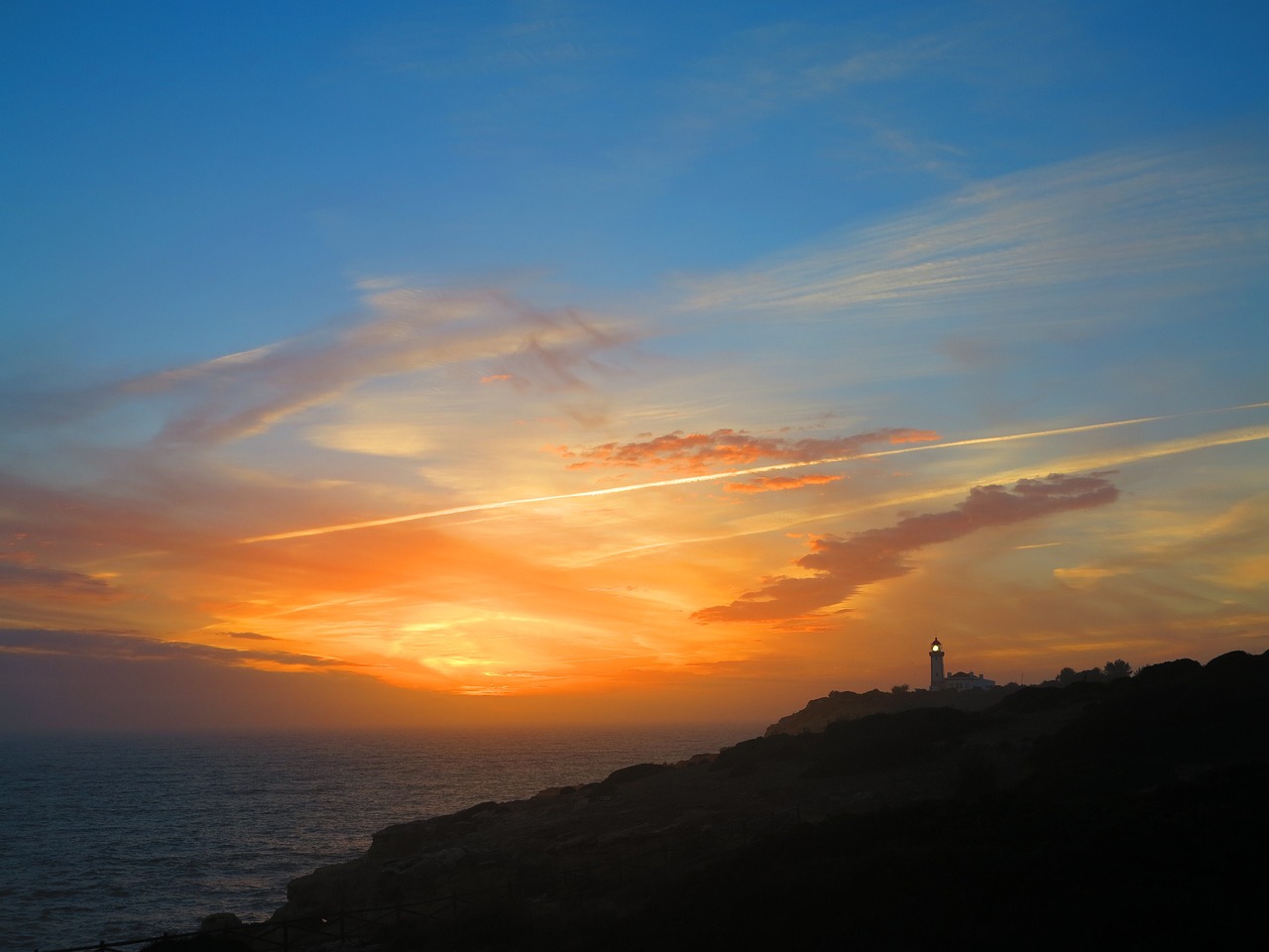 sunset lighthouse coast free photo