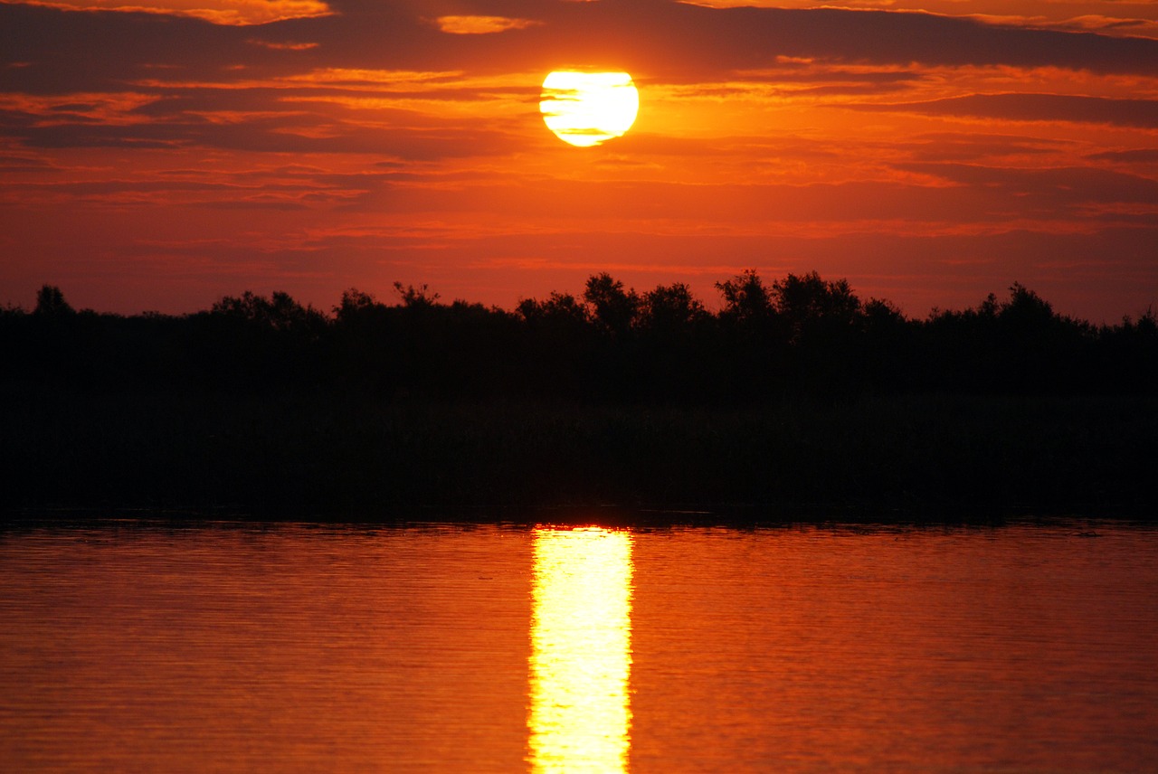 sunset body of water dawn free photo