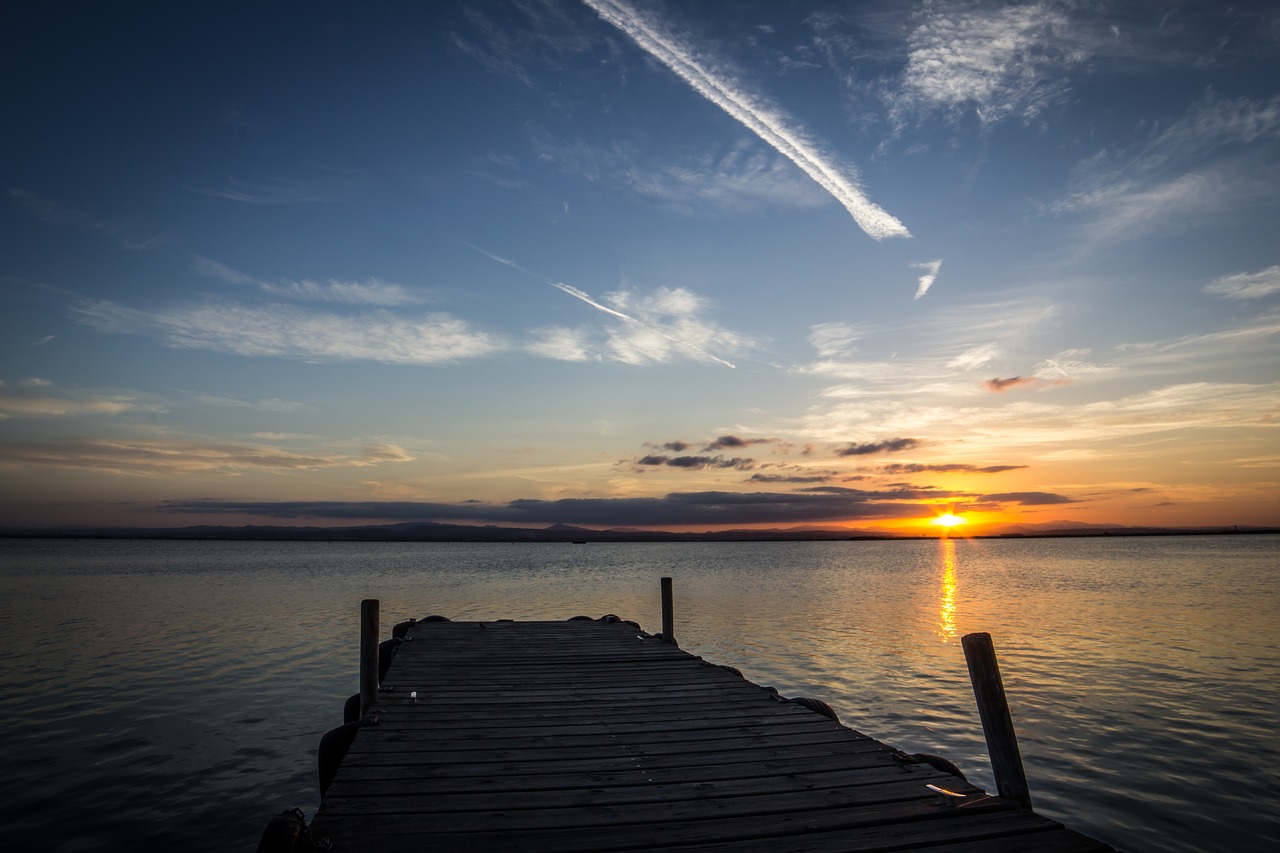 sunset body of water dawn free photo