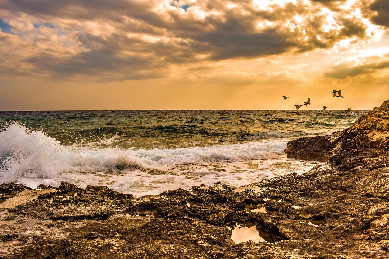 sunset  rocky coast  sea free photo