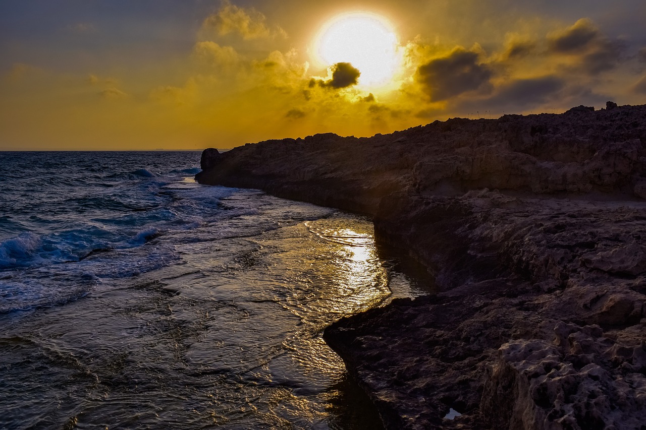 sunset  rocky coast  sea free photo