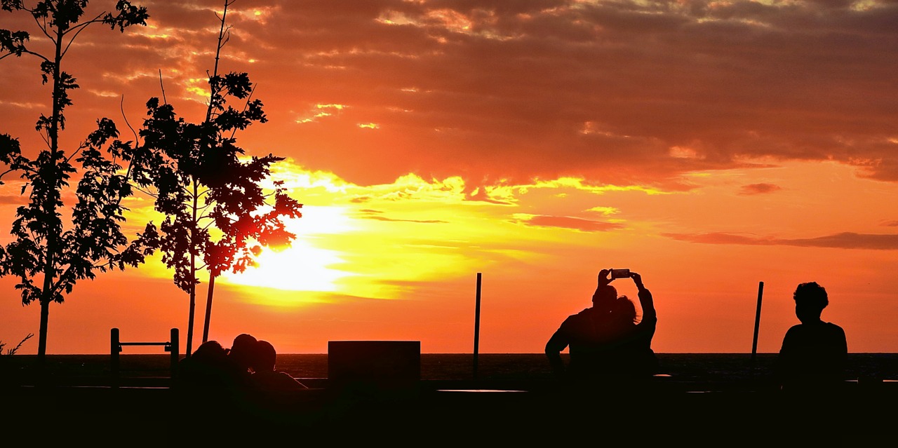 sunset  people doing pictures  a pair of lovers free photo