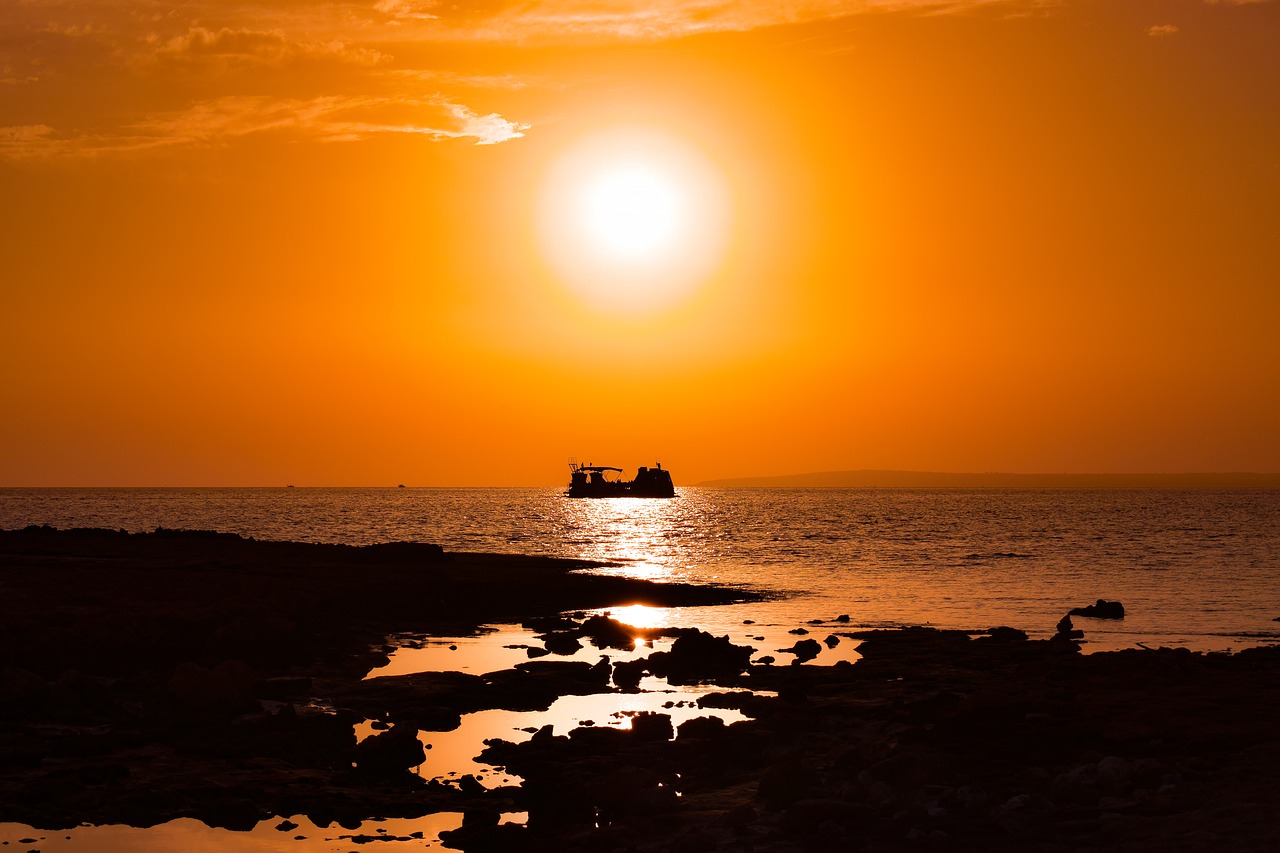 sunset  rocky coast  sun free photo