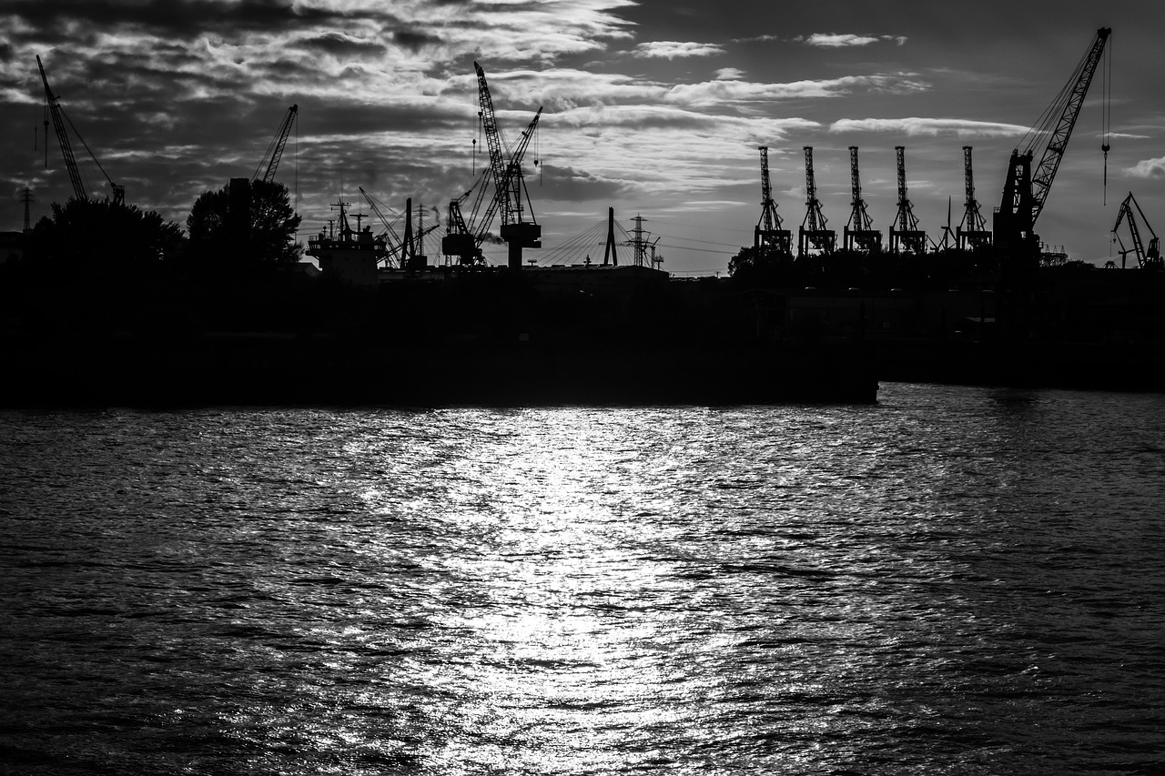sunset  container cranes  river free photo