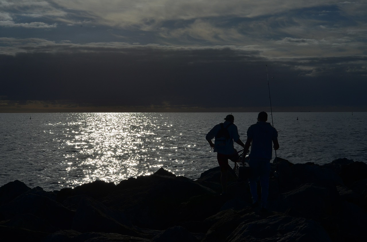 sunset fisherman coast free photo