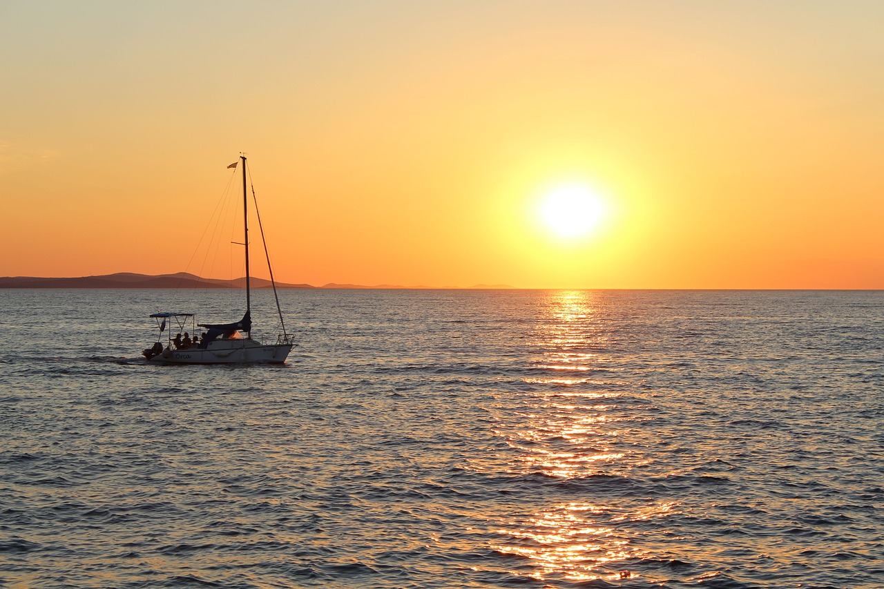 sunset  sea  boat free photo