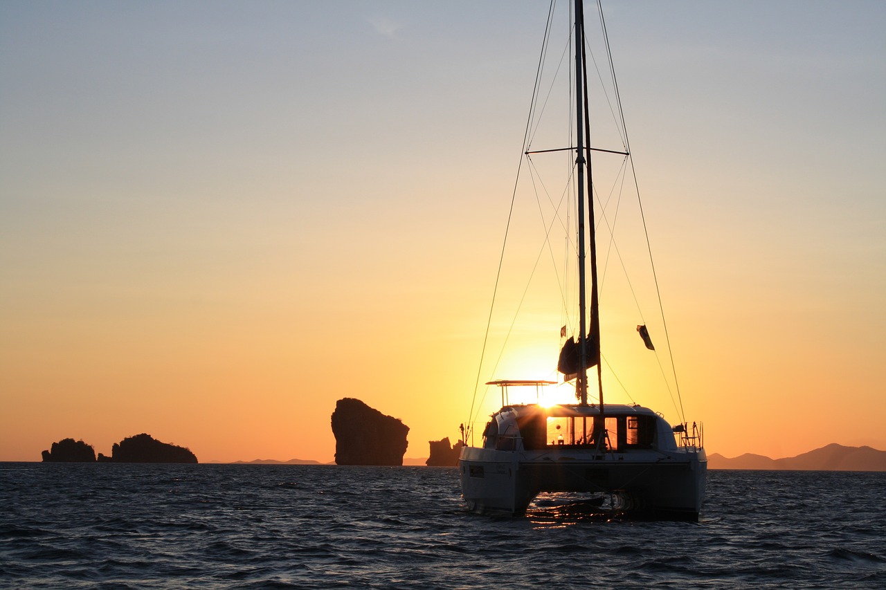 sunset  catamaran  yacht free photo