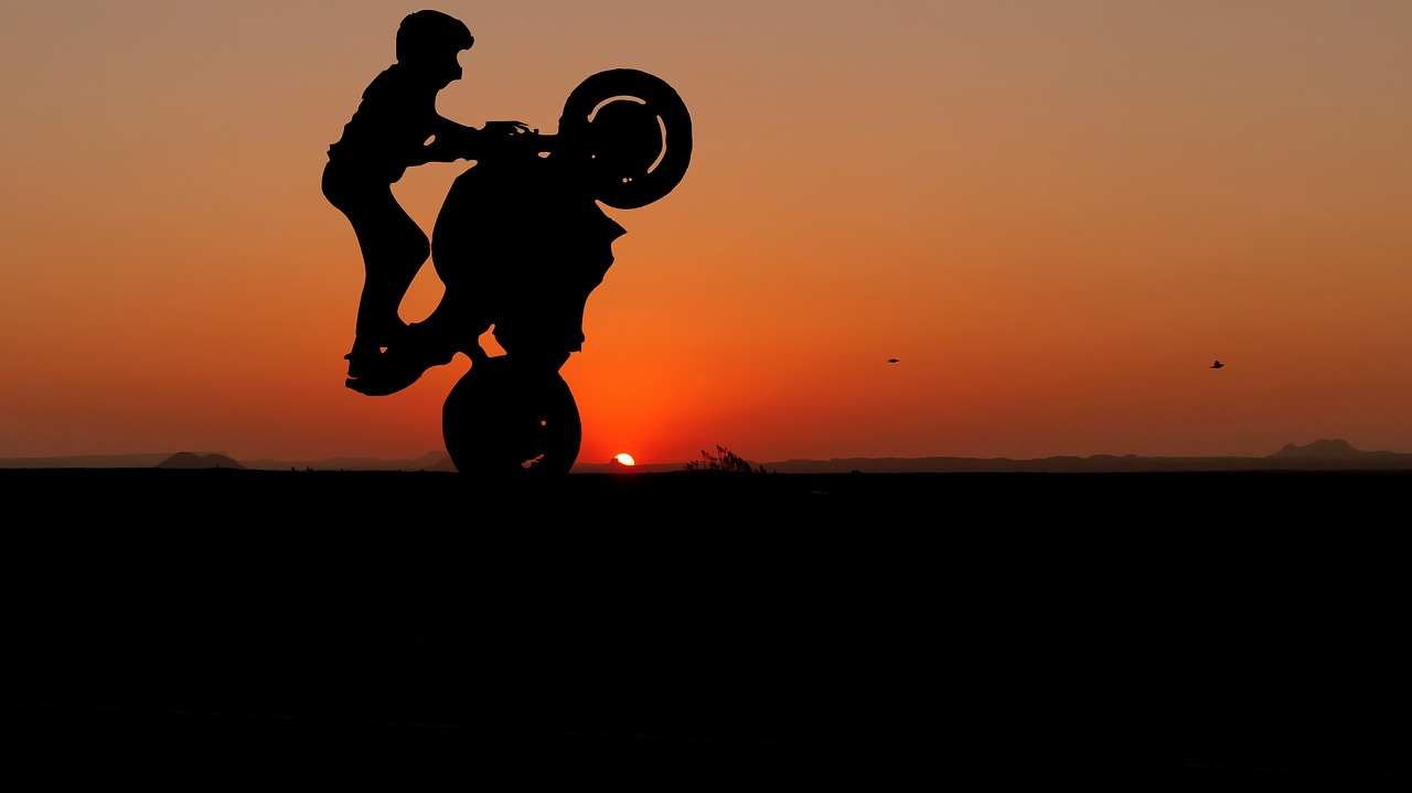 sunset  motorcycle  acrobatics free photo