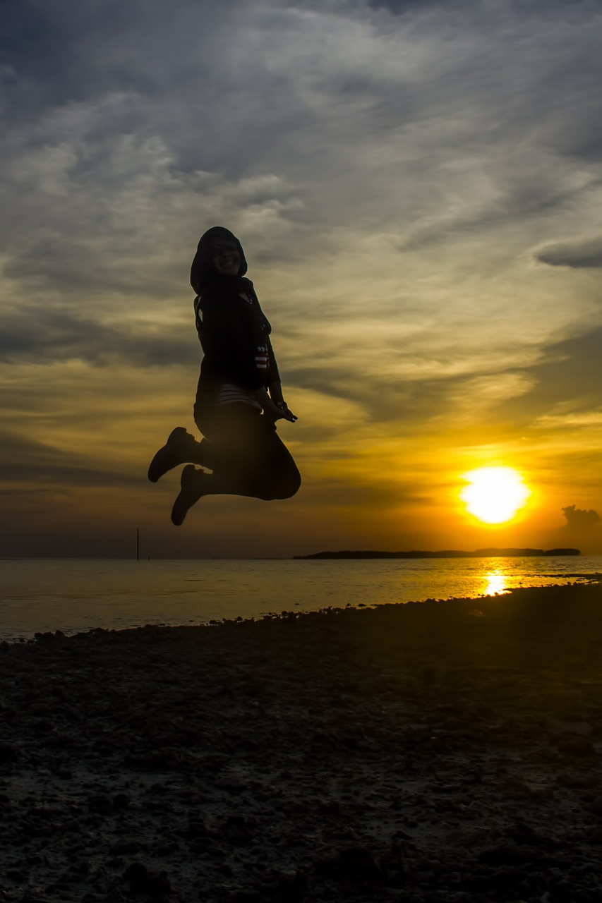 sunset jumping beach free photo