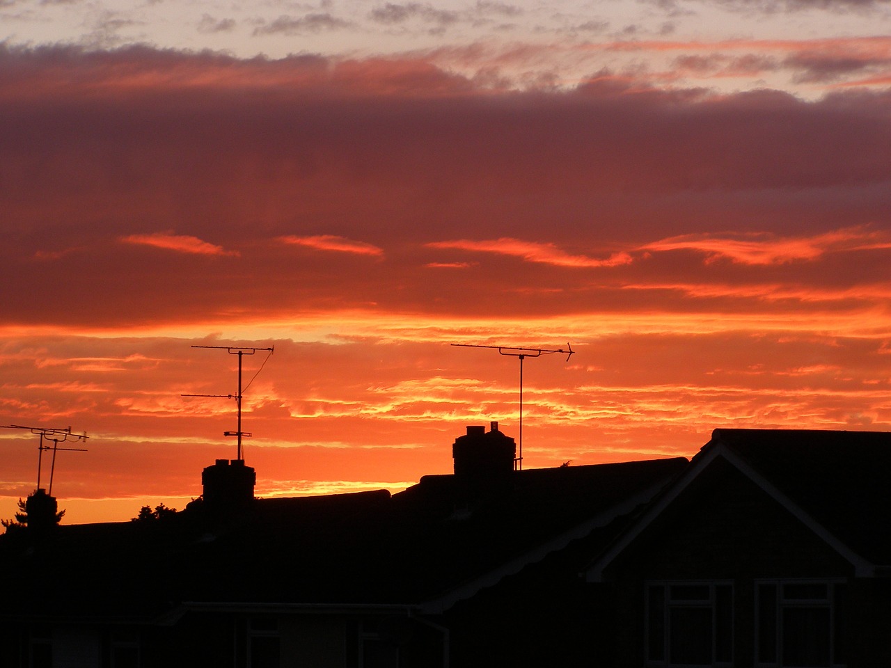 sunset silhouettes rooftops free photo