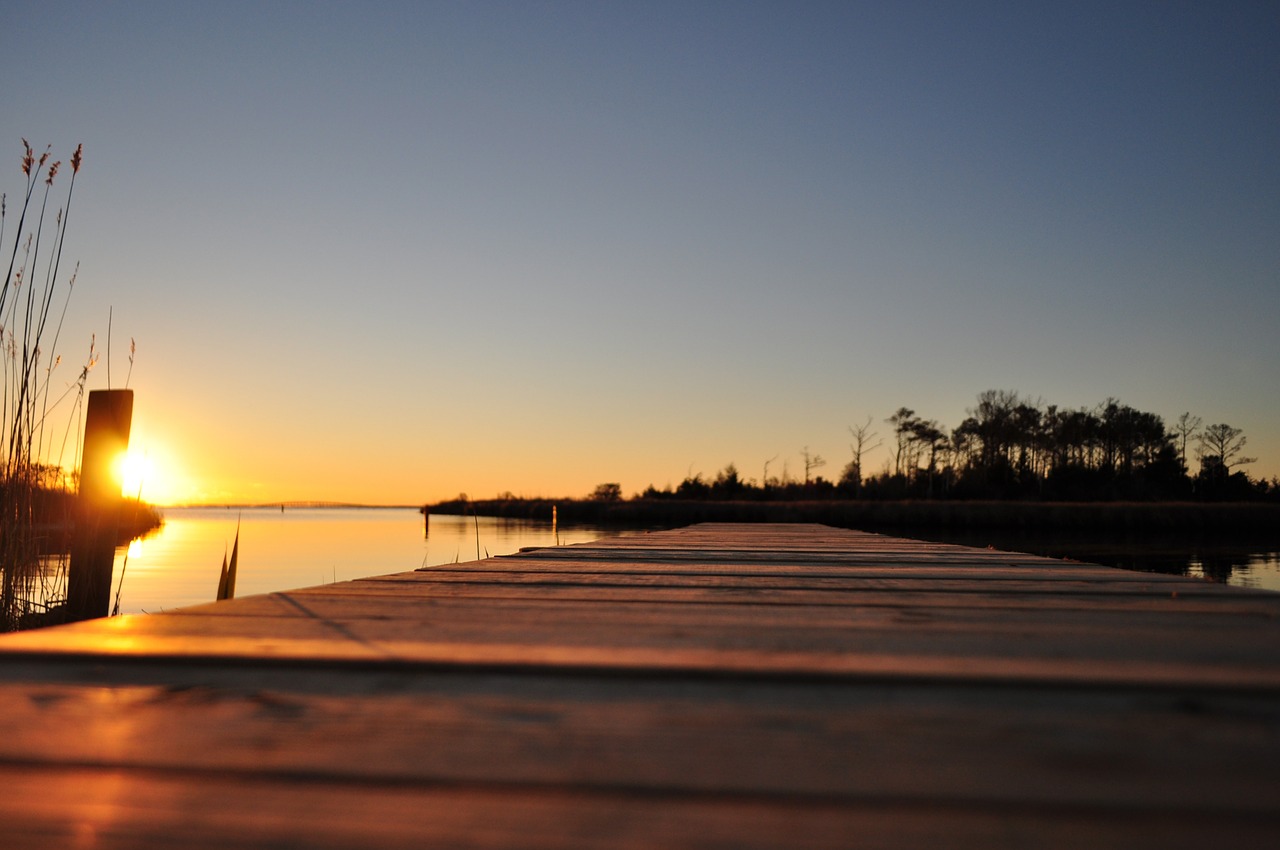 sunset boardwalk water free photo